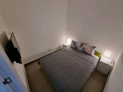 a small bedroom with a bed with a pillow at Stan na dan Beoshoping in Belgrade