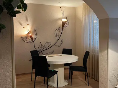 a dining room with a white table and chairs at R&R apartment Medak 3 in Belgrade