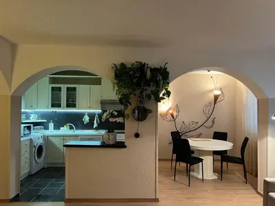 a kitchen with a table and a dining room at R&R apartment Medak 3 in Belgrade