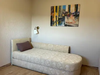 a couch in a room with a painting on the wall at R&R apartment Medak 3 in Belgrade
