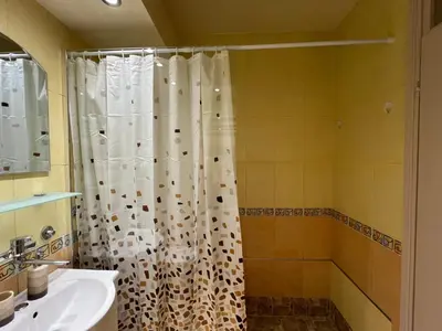 a bathroom with a shower curtain and a sink at R&R apartment Medak 3 in Belgrade