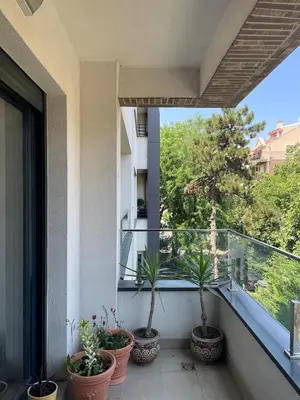 a balcony with three potted plants on it at mir i harmonija in Belgrade