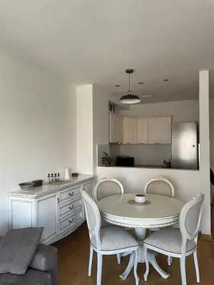 a kitchen and a table and chairs in a room at mir i harmonija in Belgrade