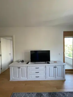 a white entertainment center with a flat screen tv on it at mir i harmonija in Belgrade
