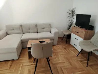 a living room with a couch and a table at EXPO Prime New Belgrade Ledine in Ledine