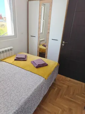 a bedroom with a bed with two towels on it at EXPO Prime New Belgrade Ledine in Ledine