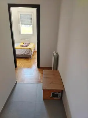 a room with a table and a bed and a mirror at EXPO Prime New Belgrade Ledine in Ledine