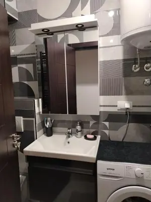 a bathroom with a sink and a washing machine at EXPO Prime New Belgrade Ledine in Ledine