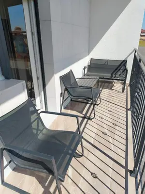 a group of chairs sitting on a balcony at EXPO Prime New Belgrade Ledine in Ledine