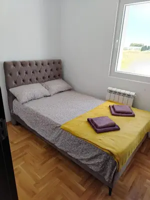a bed with two towels on it in a bedroom at EXPO Prime New Belgrade Ledine in Ledine