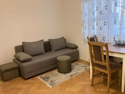 a living room with a couch and a table at Cozy apartment - Downtown in Belgrade
