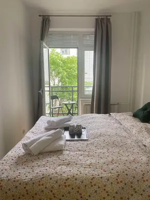 a bed with two pillows and a tray on it at Cozy apartment - Downtown in Belgrade