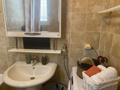 a bathroom with a sink and a mirror at Cozy apartment - Downtown in Belgrade