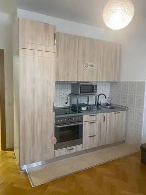 a kitchen with a stove and a microwave at Cozy apartment - Downtown in Belgrade