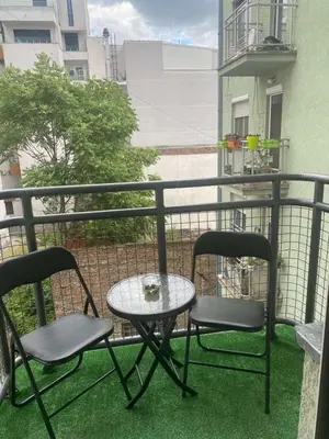 two chairs and a table on a balcony at Cozy apartment - Downtown in Belgrade