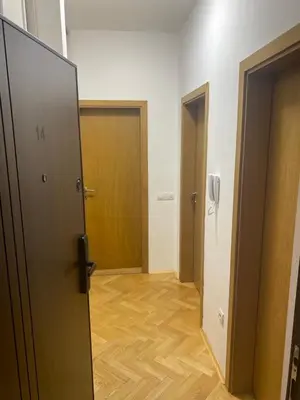 a hallway with two doors and a wooden floor at Cozy apartment - Downtown in Belgrade