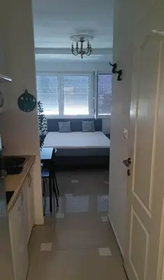 a small room with a bed in the window at Ogi apartment Beograd in Belgrade