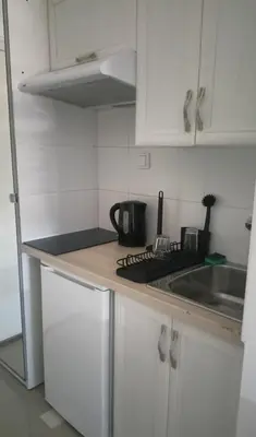 a kitchen with white cabinets and a counter top at Ogi apartment Beograd in Belgrade