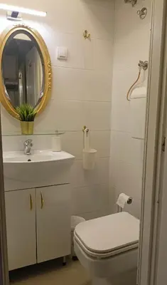 a bathroom with a toilet and a sink and a mirror at Ogi apartment Beograd in Belgrade