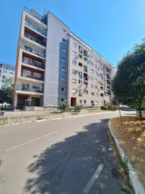 an empty street in front of a large building at Amar6 in Novi Beograd
