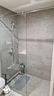 a shower with a glass door in a bathroom at Sava Lux in Sajmište