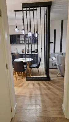 a dining room and living room with a table and chairs at Sava Lux in Sajmište