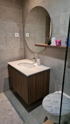 a bathroom with a sink and a mirror and a toilet at Sava Lux in Sajmište