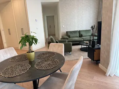a living room with a table and chairs at BW AQUA Joi Lux 2 Apartment in Belgrade