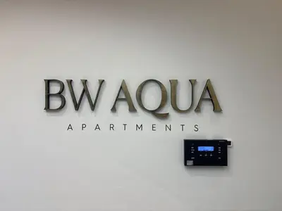 a sign for the bvlgariarmaarmaarma organisation on a wall at BW AQUA Joi Lux 2 Apartment in Belgrade