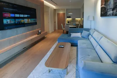a living room with a blue couch and a coffee table at Scala Reale in Sajmište