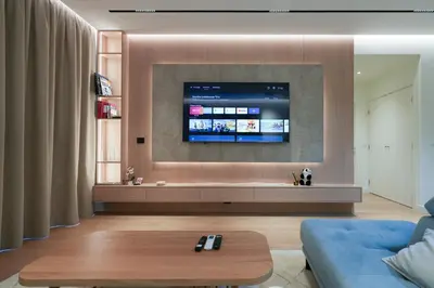 a living room with a tv on a wall at Scala Reale in Sajmište