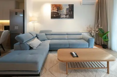 a living room with a blue couch and a coffee table at Scala Reale in Sajmište