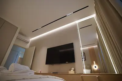 a bedroom with a large mirror and a flat screen tv at Scala Reale in Sajmište