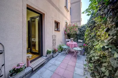 a patio with a table and chairs in a building at Oasis Moonze in Zemun