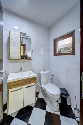 a bathroom with a toilet and a sink and a mirror at Oasis Moonze in Zemun