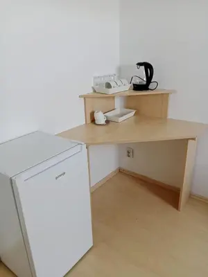 a wooden desk with a phone on top of it at Stan Na Dan - Mladenovac in Mladenovac