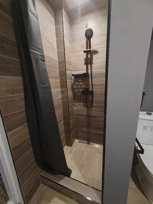 a shower with a glass door in a bathroom at Airport Apartment AIR 2 in Surčin