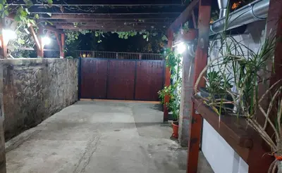 an empty patio with a fence and some plants at Airport Apartment AIR 2 in Surčin