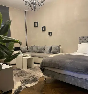 a living room with a bed and a couch at Okapi stays in Belgrade