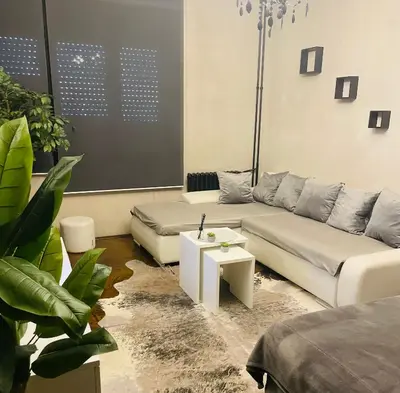 a living room with a couch and a table at Okapi stays in Belgrade