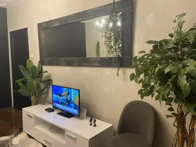 a living room with a computer on a white desk at Okapi stays in Belgrade