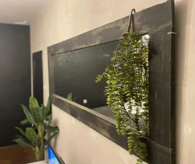 a plant in a wooden box on a wall at Okapi stays in Belgrade