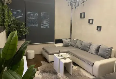 a living room with a couch and a table at Okapi stays in Belgrade
