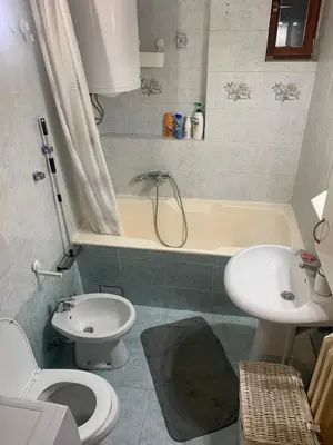 a bathroom with a toilet and a sink and a tub at Urban nest Slavija in Belgrade