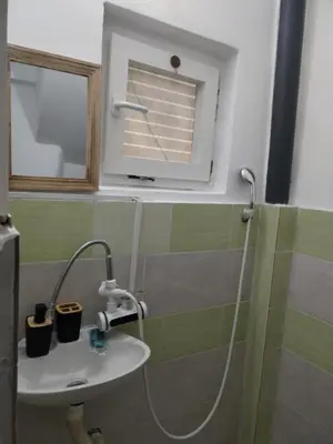 a bathroom with a sink and a mirror at Apartman M&D in Pančevo