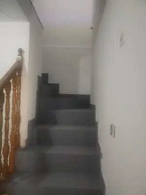 a staircase in a house with grey stairs at Apartman M&D in Pančevo