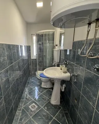 a bathroom with a sink and a toilet and a mirror at Forest House in Beljina