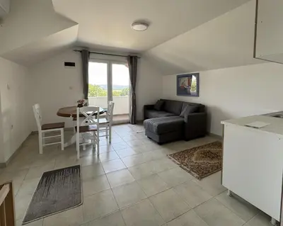 a living room with a couch and a table at Forest House in Beljina