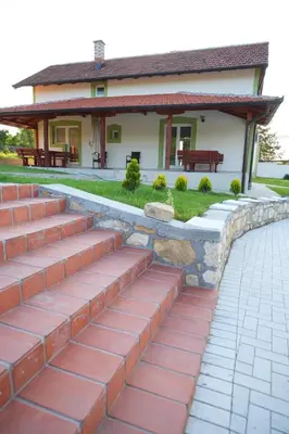 a brick walkway in front of a house at Forest House in Beljina