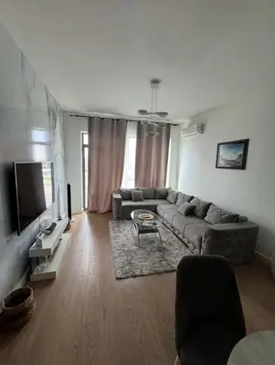 a living room with a couch and a tv at Beograd na vodi VSLE in Belgrade